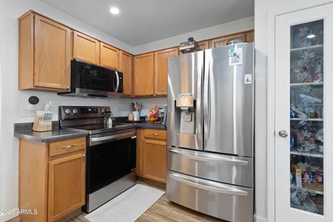 a kitchen with stainless steel appliances granite countertop a refrigerator stove and microwave