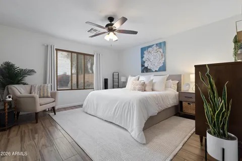 a bedroom with a large bed and a chandelier