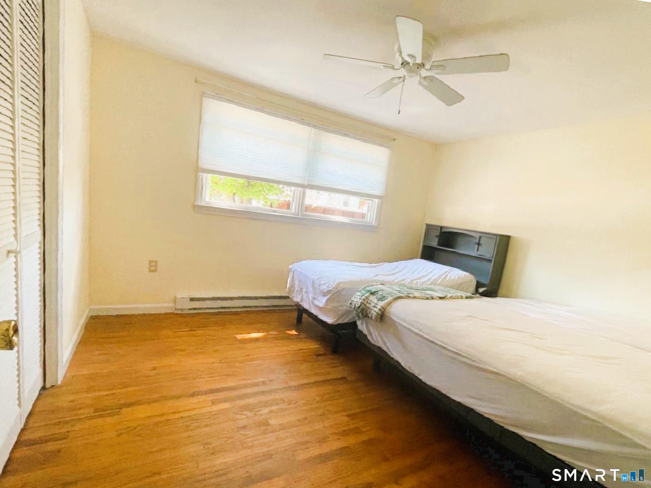 18 Old South Cove Road Old Saybrook, CT 06475 - Photo 27 of 40 a bedroom with a bed and a ceiling fan