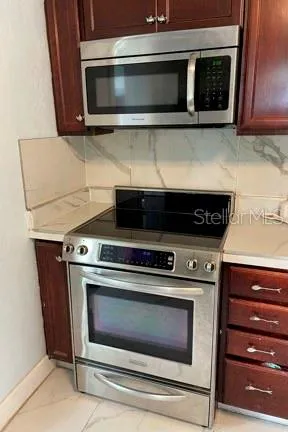 a kitchen with a stove and a microwave
