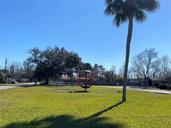 a swimming pool with trees in the background