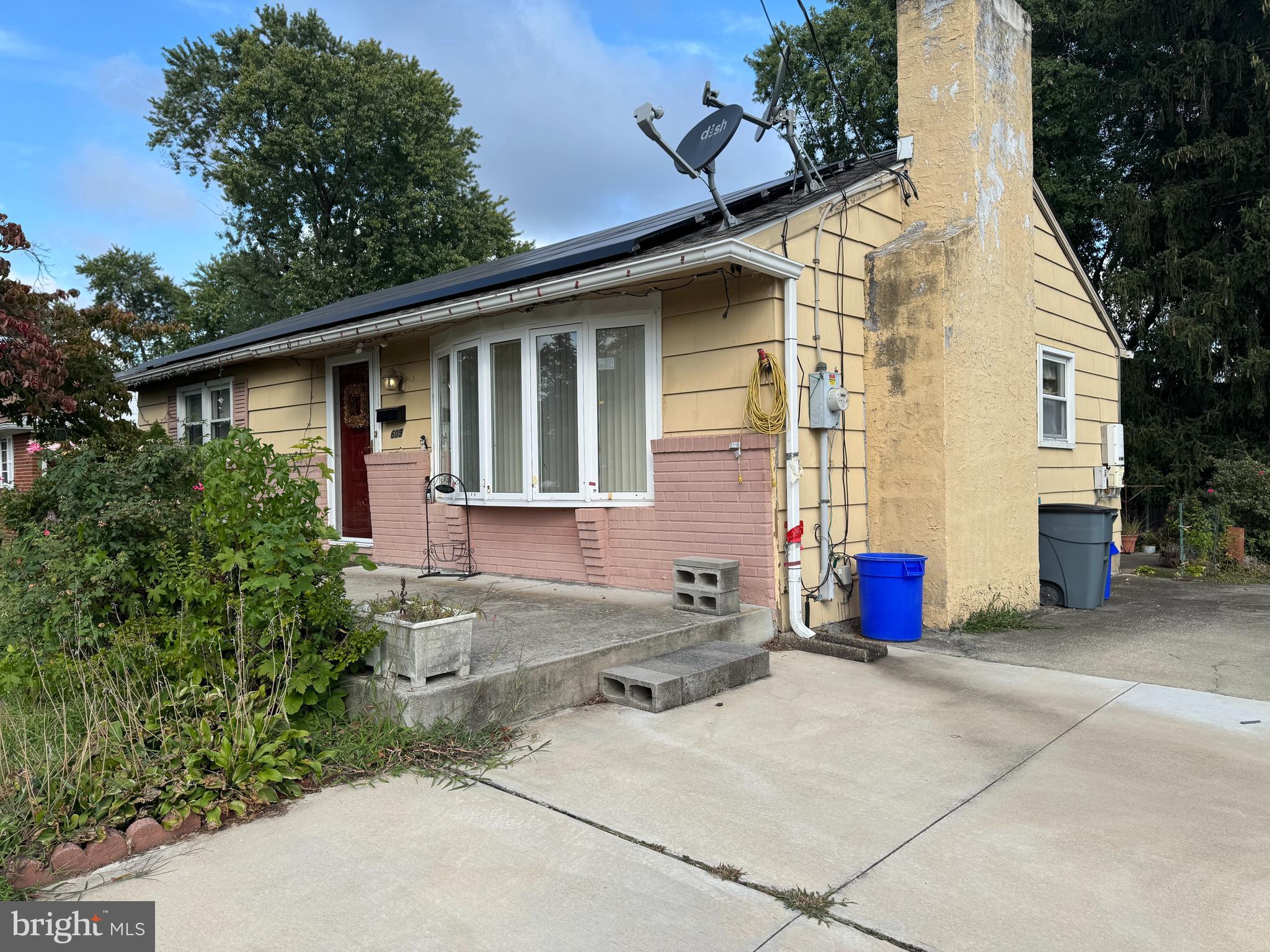 609 Evesham Avenue West Magnolia, NJ 08049 - Photo 2 of 73 a view of a white house with large windows and potted plants