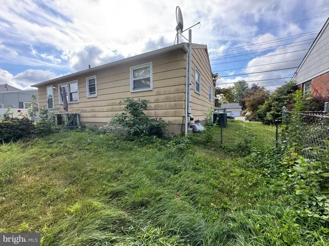 a backyard of a house with plants and garden