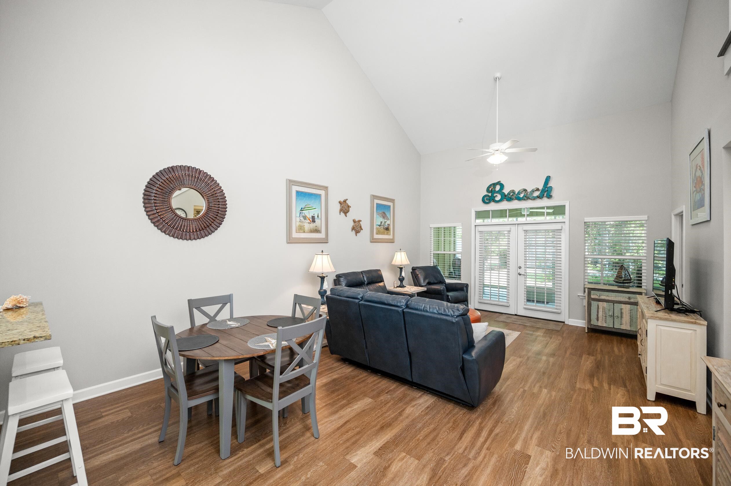 430 West Fort Morgan Road, Unit 1902 Gulf Shores, AL 36542 - Photo 10 of 59 Living room with ceiling fan, french doors, hardwood / wood-style floors, and high vaulted ceiling