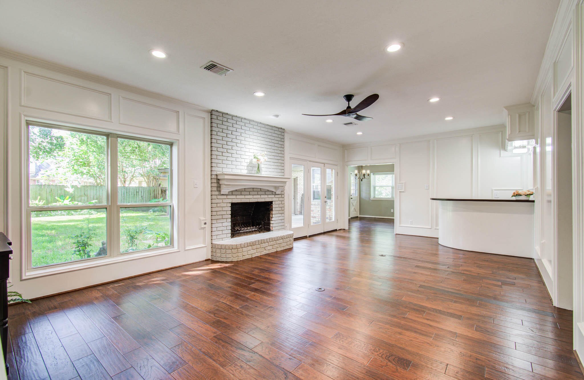16267 Salmon Lane Spring, TX 77379 - Photo 12 of 48 an empty room with wooden floor a fireplace and windows
