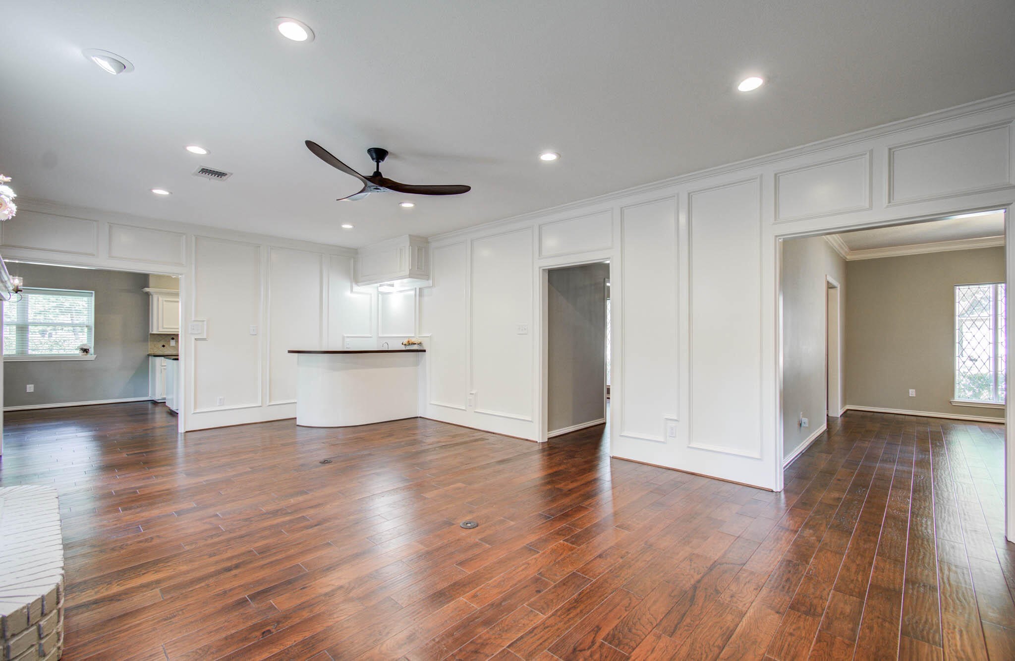 16267 Salmon Lane Spring, TX 77379 - Photo 13 of 48 a view of an empty room with wooden floor and a kitchen