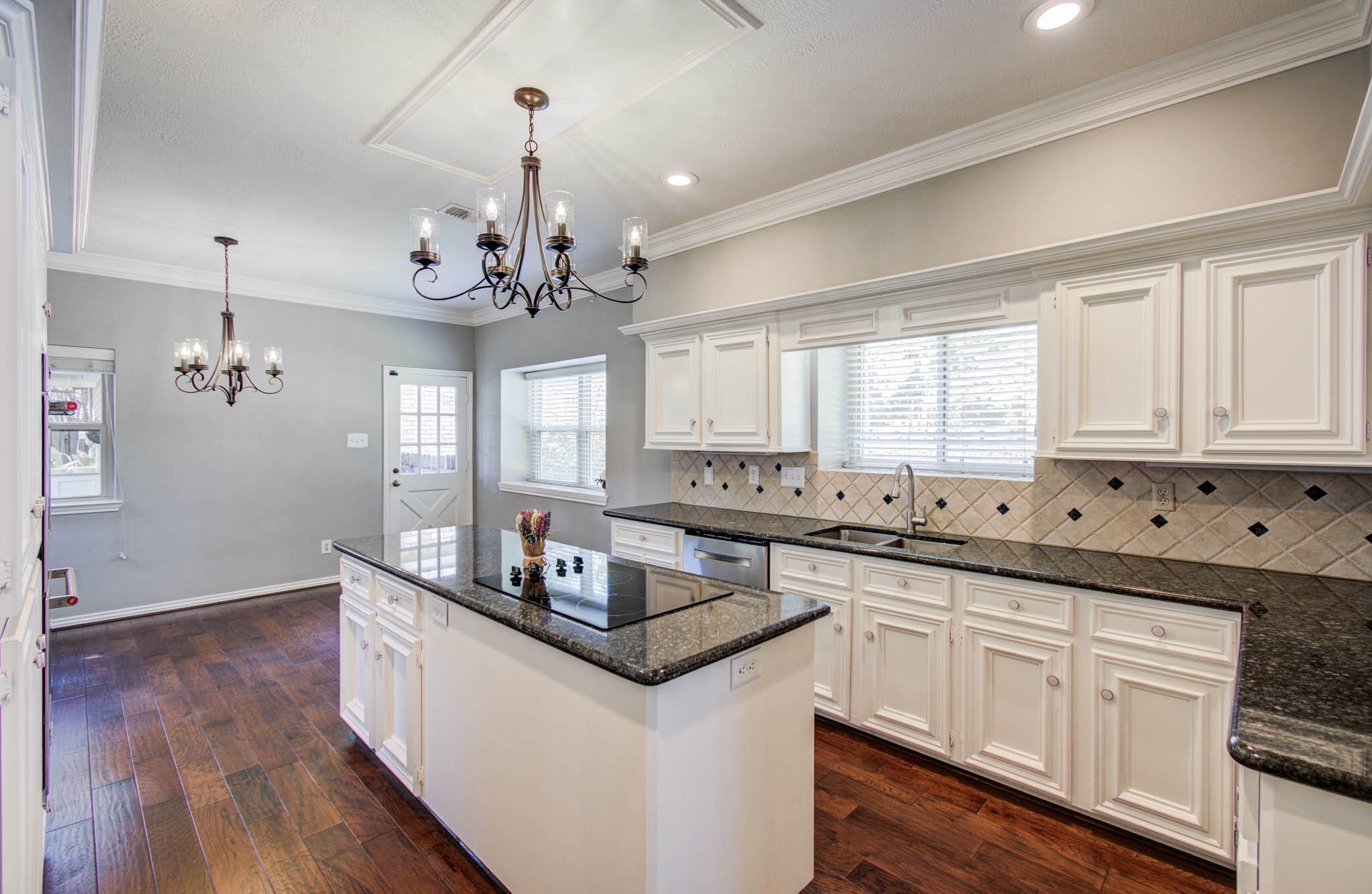 16267 Salmon Lane Spring, TX 77379 - Photo 18 of 48 a kitchen with granite countertop a sink cabinets a window and stainless steel appliances