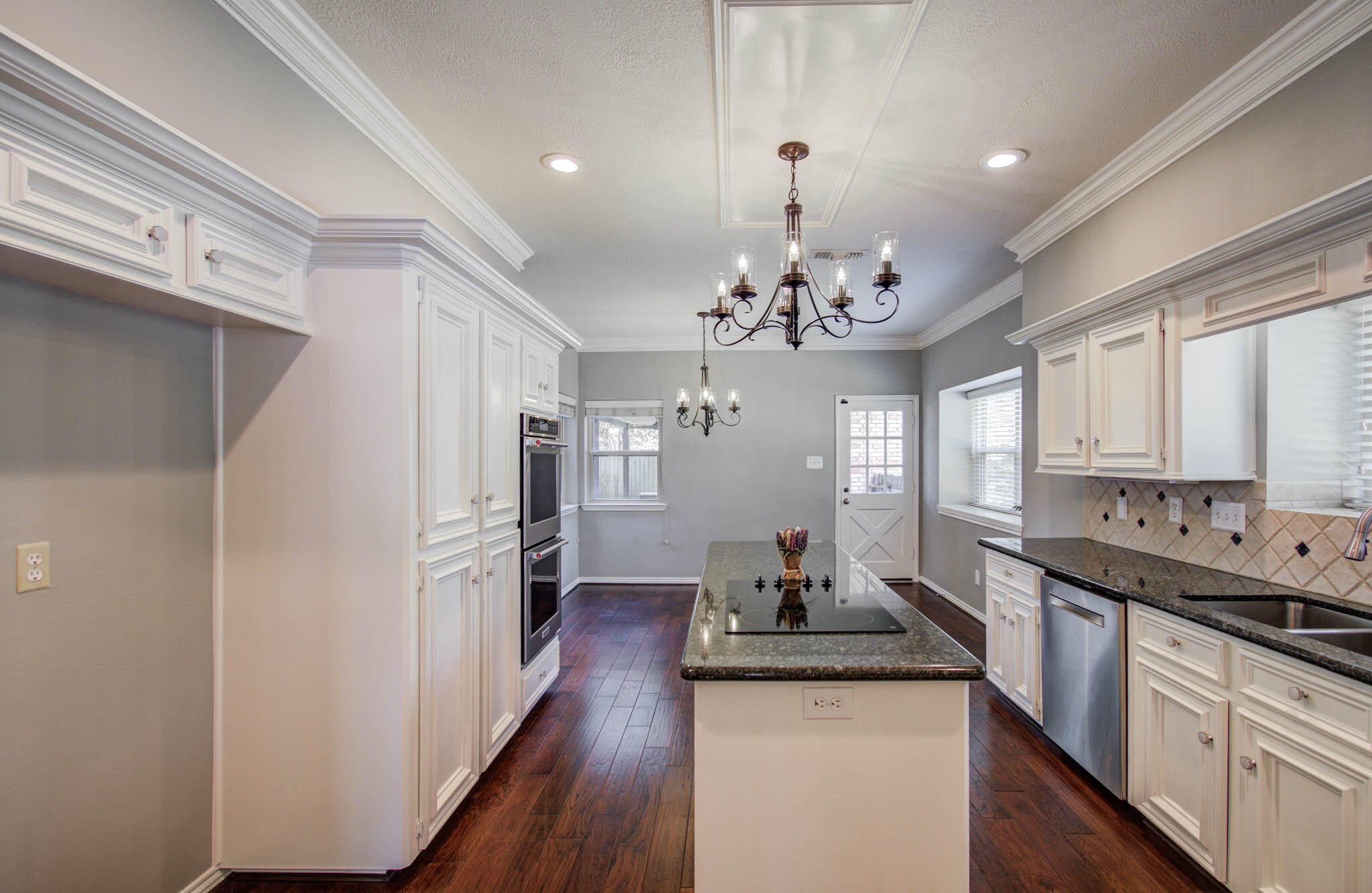 16267 Salmon Lane Spring, TX 77379 - Photo 20 of 48 a large kitchen with stainless steel appliances a chandelier and wooden floor