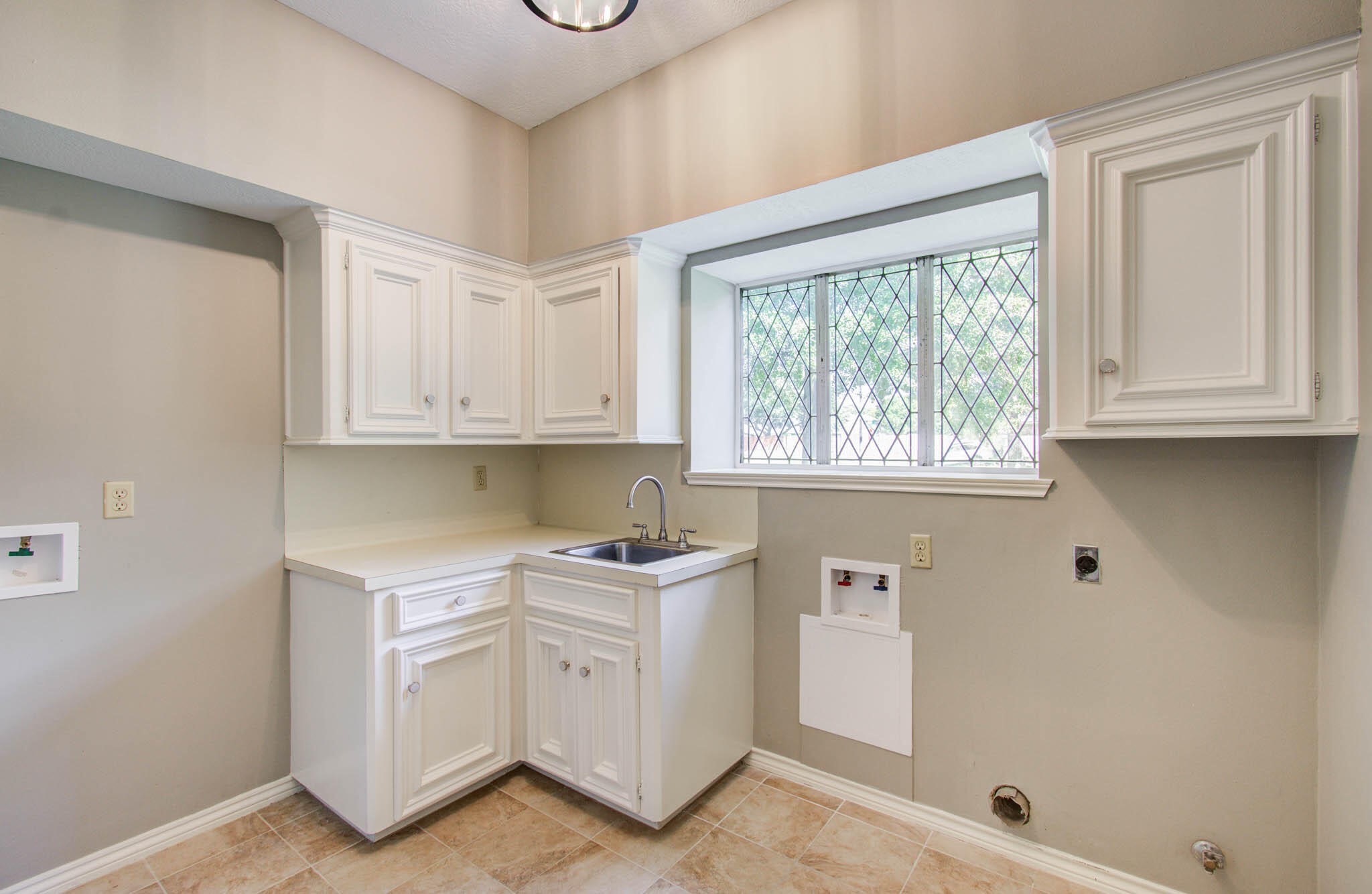 16267 Salmon Lane Spring, TX 77379 - Photo 21 of 48 a kitchen with white cabinets and window