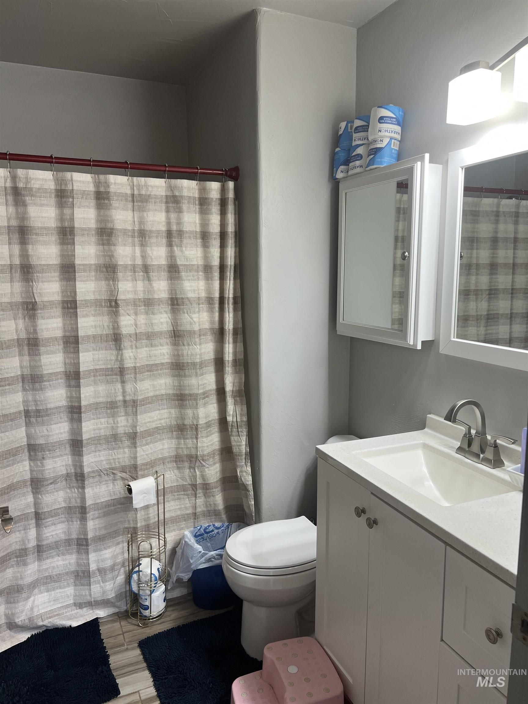 121 North 1st Street Nyssa, OR 97913 - Photo 13 of 20 Bathroom featuring a white vanity with integrated sink, chrome faucet, and white cabinetry