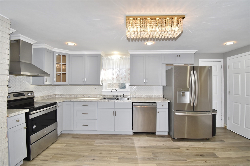 85 Orchard Street Chicopee, MA 01013 - Photo 1 of 33 a kitchen with stainless steel appliances granite countertop a stove top oven a sink and a refrigerator