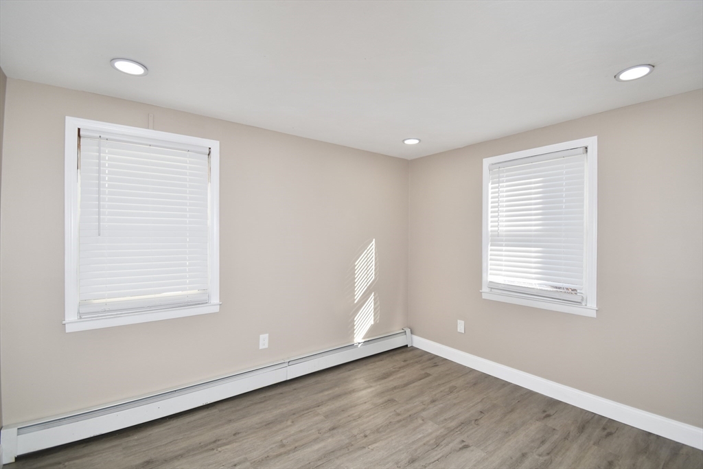 85 Orchard Street Chicopee, MA 01013 - Photo 11 of 33 a view of an empty room with wooden floor and a window