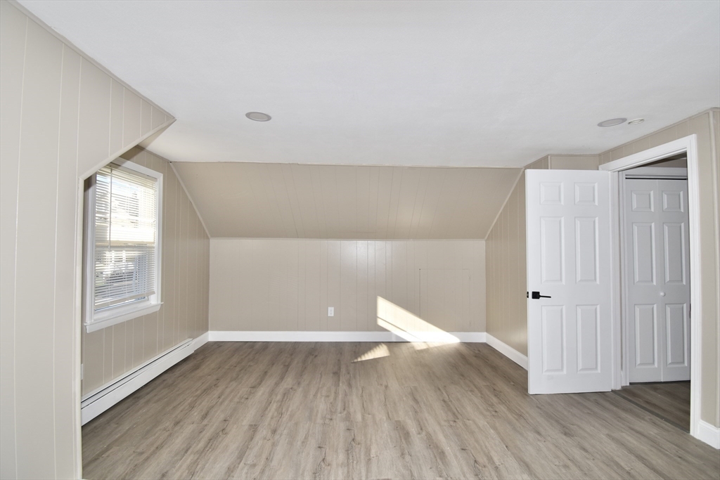 85 Orchard Street Chicopee, MA 01013 - Photo 12 of 33 an empty room with wooden floor and windows