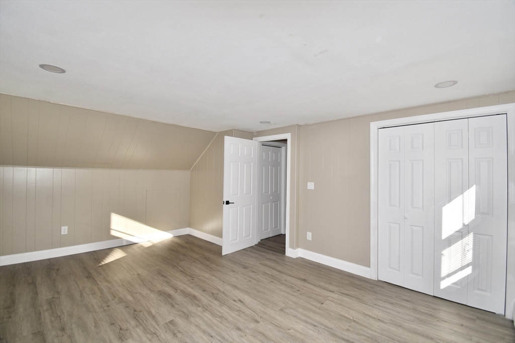 85 Orchard Street Chicopee, MA 01013 - Photo 13 of 33 a view of an empty room with wooden floor and a window