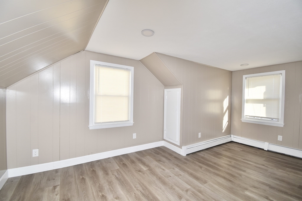 85 Orchard Street Chicopee, MA 01013 - Photo 14 of 33 an empty room with wooden floor and windows