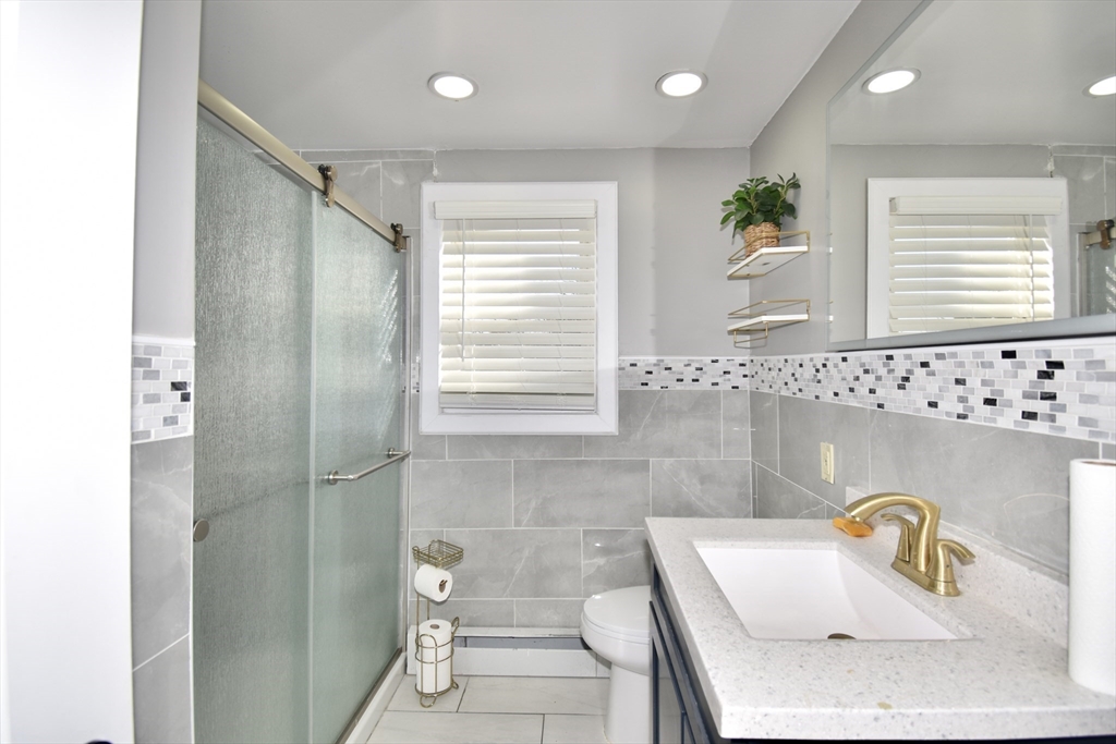 85 Orchard Street Chicopee, MA 01013 - Photo 15 of 33 a bathroom with a sink a toilet and shower