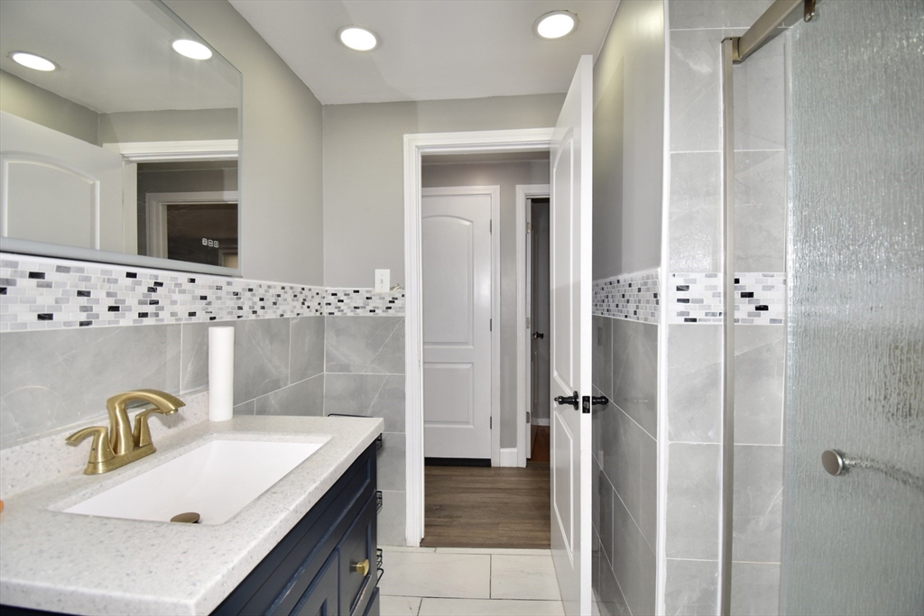 85 Orchard Street Chicopee, MA 01013 - Photo 16 of 33 a bathroom with a sink vanity granite tub and shower