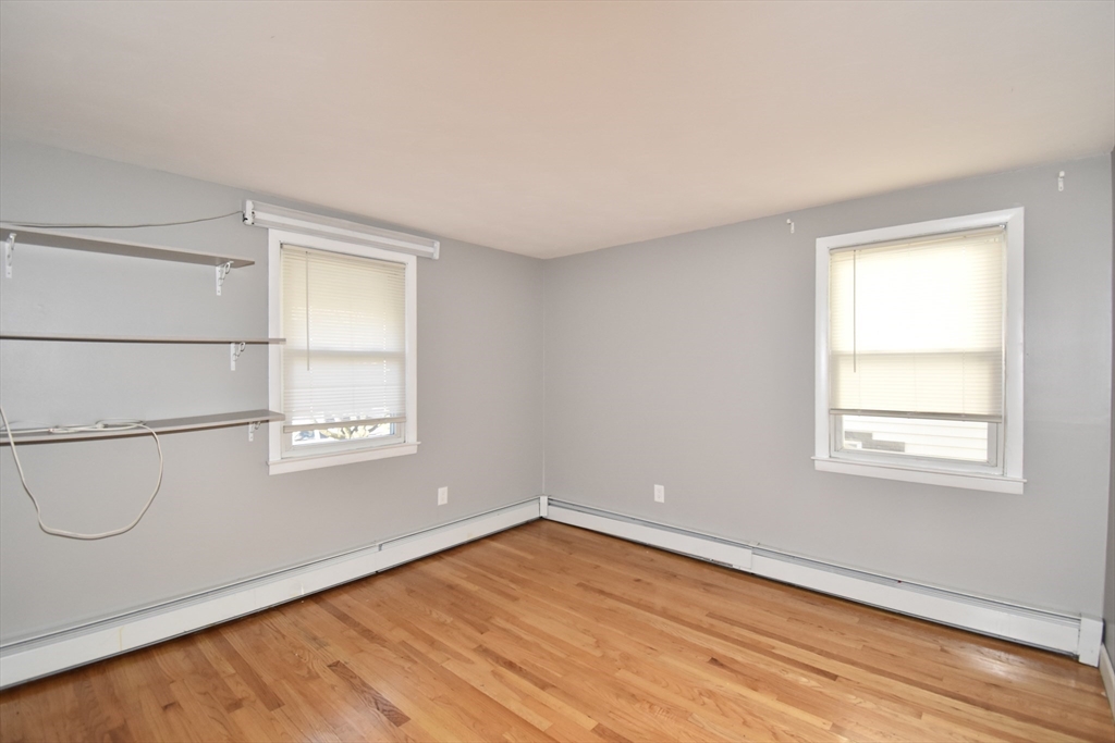 85 Orchard Street Chicopee, MA 01013 - Photo 18 of 33 an empty room with wooden floor and windows