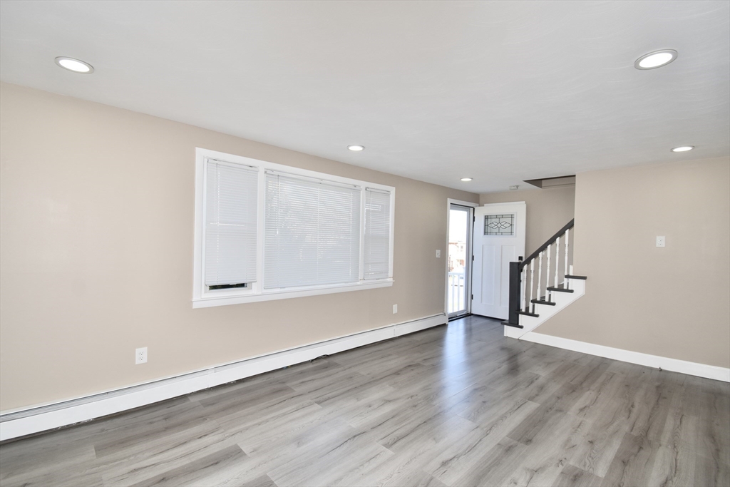 85 Orchard Street Chicopee, MA 01013 - Photo 7 of 33 a view of an empty room with wooden floor and a window