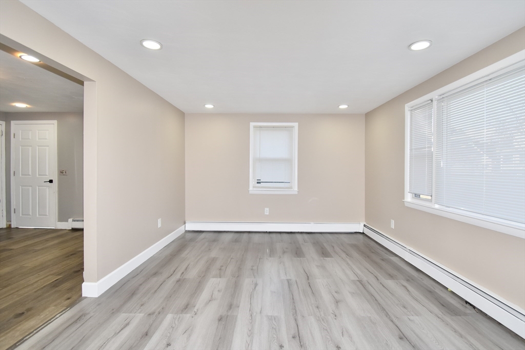 85 Orchard Street Chicopee, MA 01013 - Photo 8 of 33 wooden floor in an empty room with a window