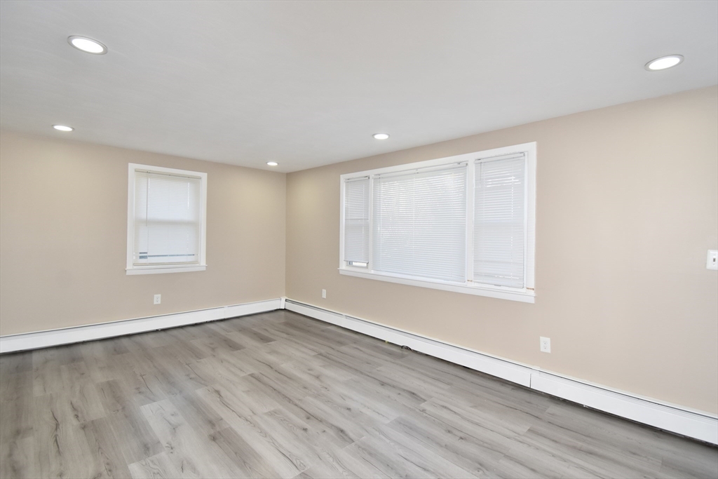 85 Orchard Street Chicopee, MA 01013 - Photo 9 of 33 an empty room with wooden floor and windows
