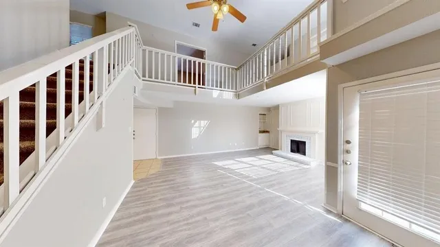 a view of staircase with white walls and a window