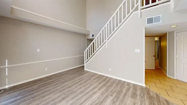 a view of an entryway with wooden floor