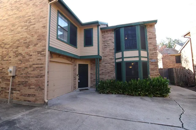 a view of a brick house with windows