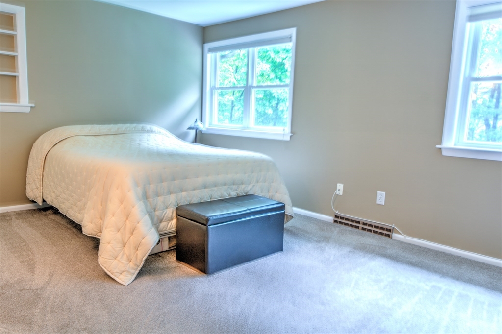 10 Long Meadow Road Chelmsford, MA 01824 - Photo 15 of 42 a bed sitting in a bedroom next to a window