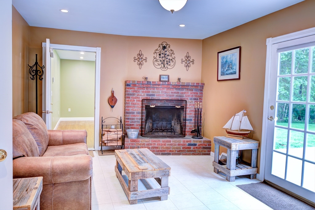 10 Long Meadow Road Chelmsford, MA 01824 - Photo 21 of 42 a living room with furniture a rug and a fireplace