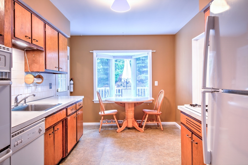 10 Long Meadow Road Chelmsford, MA 01824 - Photo 7 of 42 a kitchen with a sink stove and chairs