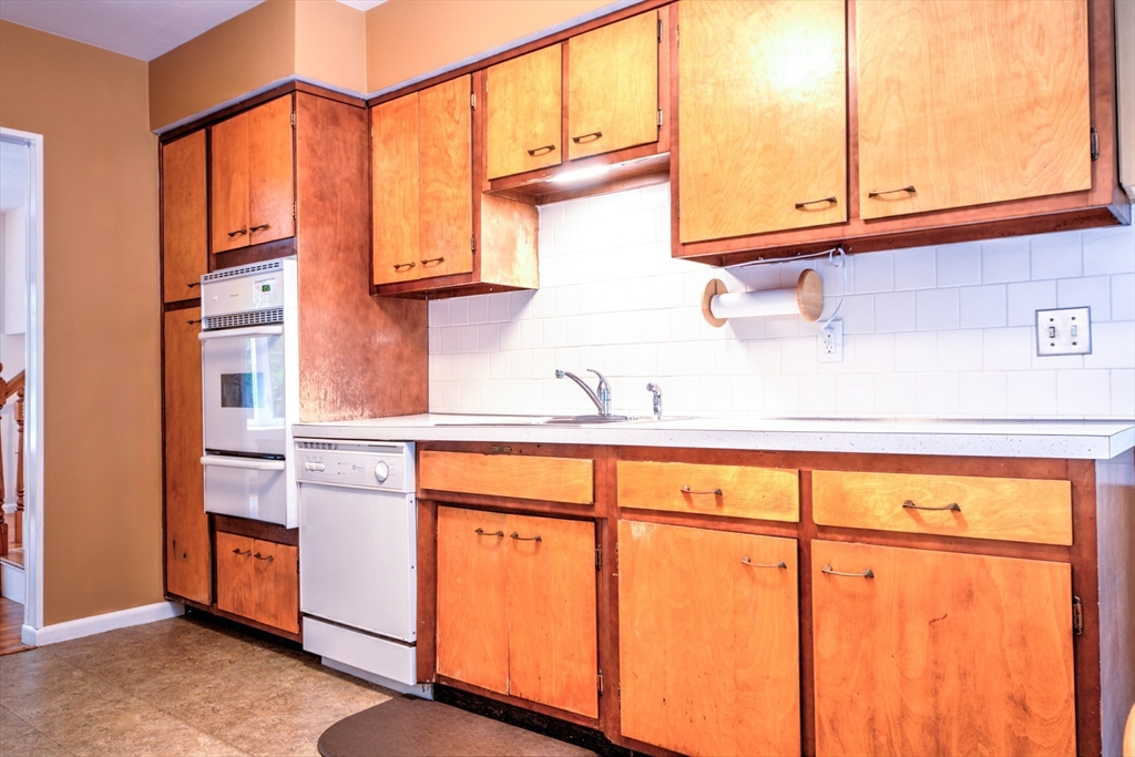 10 Long Meadow Road Chelmsford, MA 01824 - Photo 9 of 42 a kitchen with stainless steel appliances granite countertop a sink and cabinets