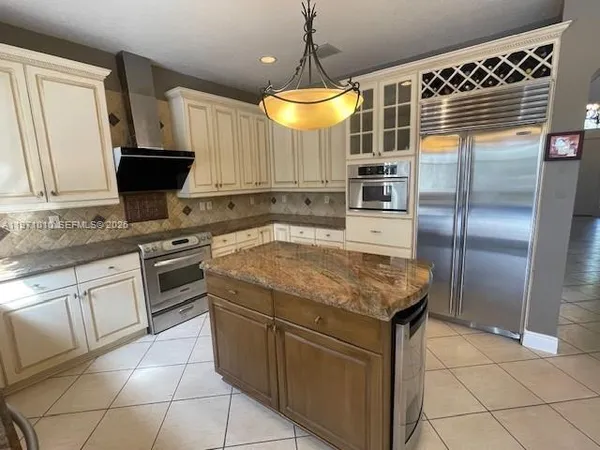 a kitchen with a stove a sink and a refrigerator