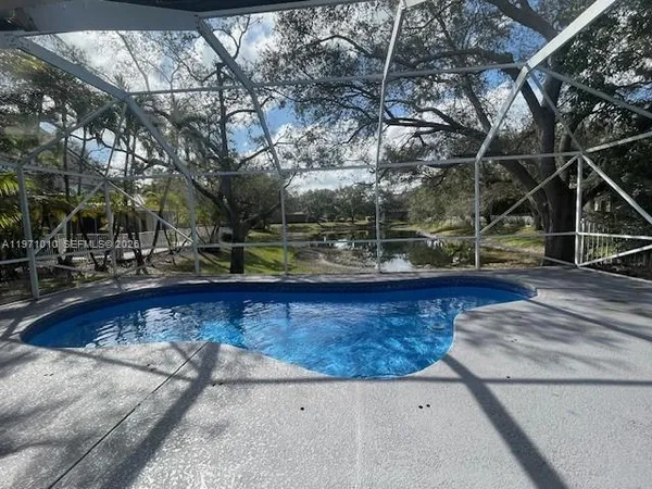 a view of a swimming pool with outdoor seating