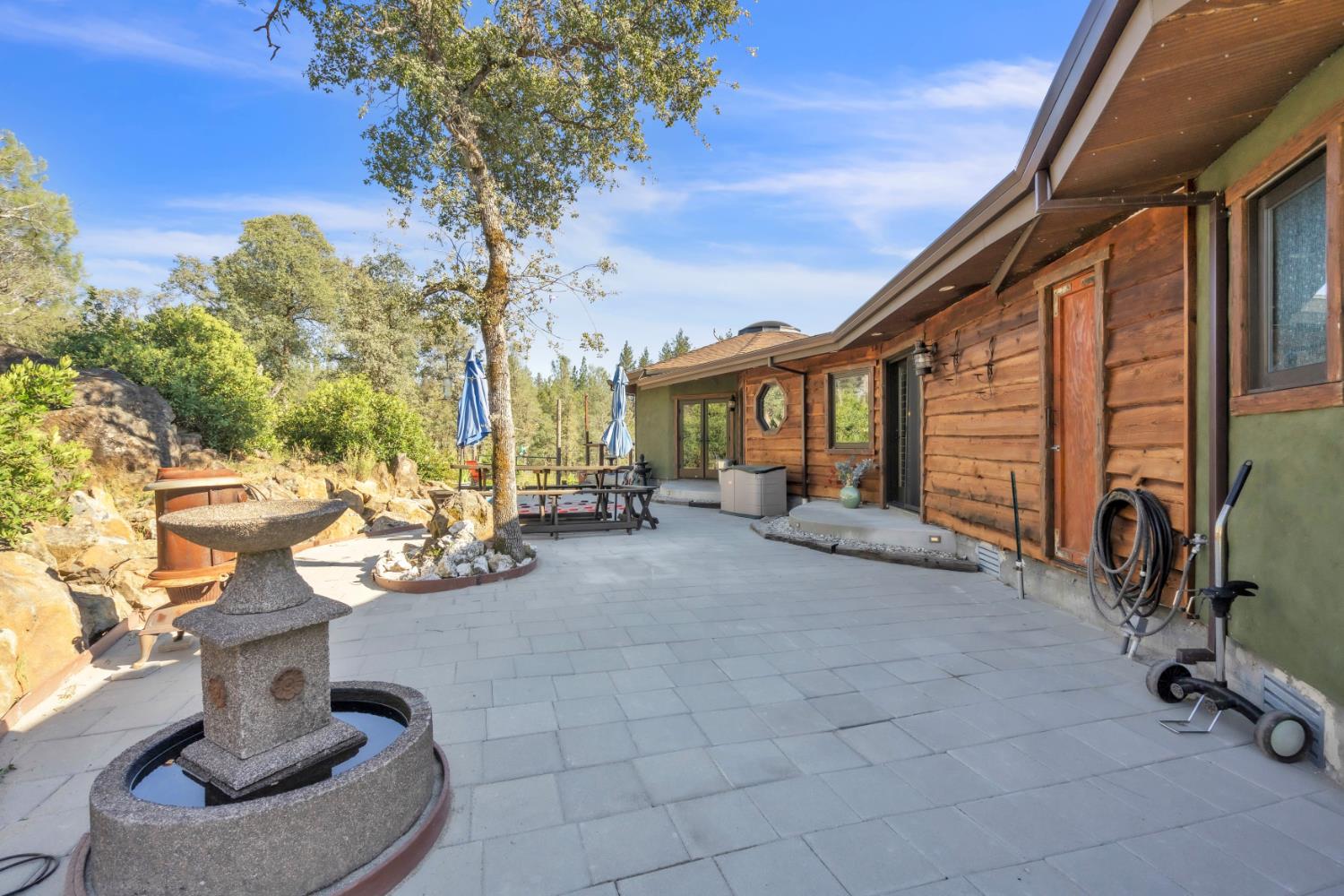 12767 Newtown Road Nevada City, CA 95959 - Photo 53 of 57 a view of a patio with table and chairs potted plants and a large tree