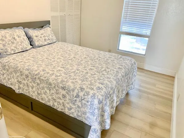 a bed sitting in a bedroom next to a window