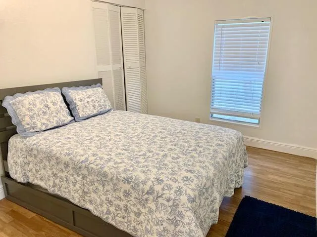 a swimming pool with outdoor seating and trees in the background