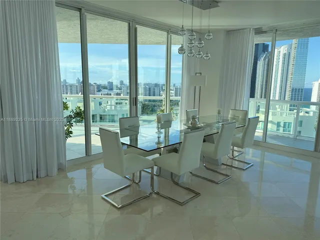 a bedroom with furniture and large windows