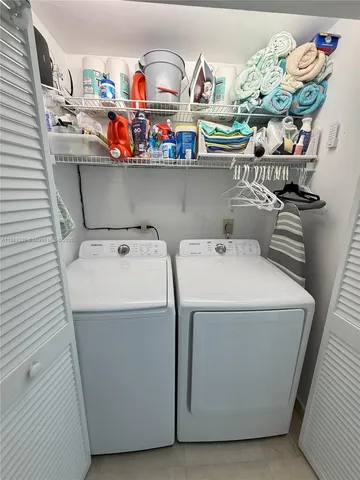 a bathroom with a sink a toilet a mirror and shower