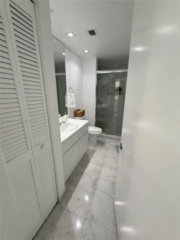 a bathroom with a shower and a toilet