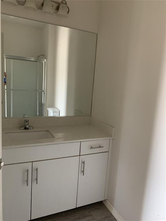 420 Teague Avenue, Unit 4 Edinburg, TX 78539 - Photo 11 of 14 a bathroom with a sink and mirror