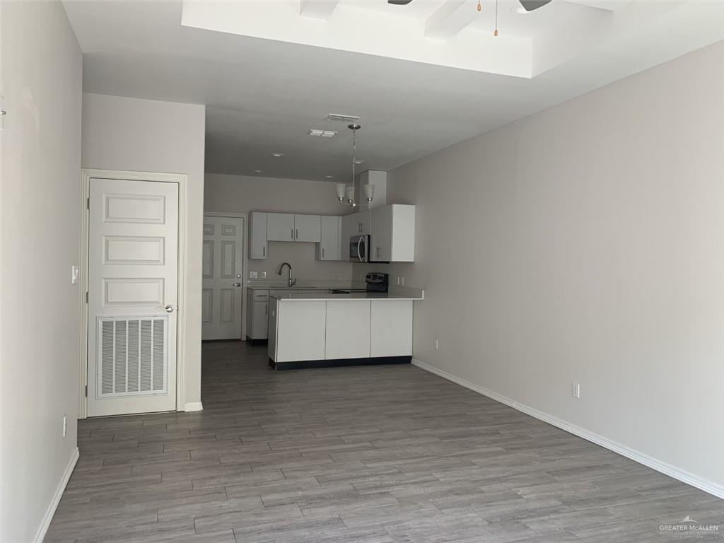 420 Teague Avenue, Unit 4 Edinburg, TX 78539 - Photo 3 of 14 a room with a bed and a view of kitchen