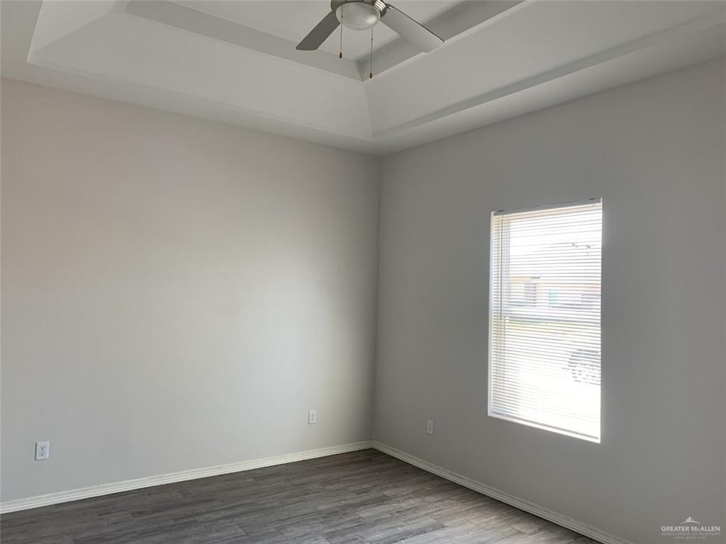 420 Teague Avenue, Unit 4 Edinburg, TX 78539 - Photo 6 of 14 wooden floor in an empty room with a window