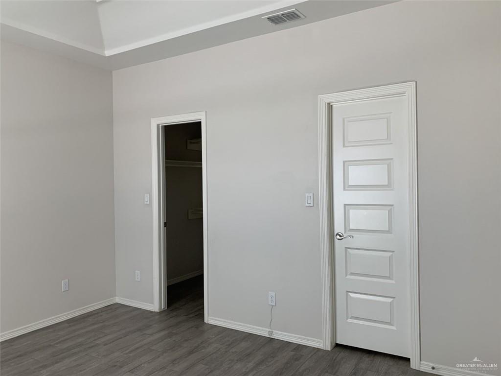 420 Teague Avenue, Unit 4 Edinburg, TX 78539 - Photo 8 of 14 an empty room with wooden floor