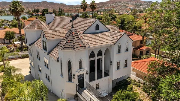 an aerial view of multiple houses with a mountain
