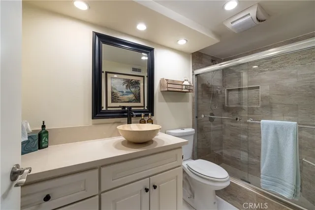 a bathroom with a toilet a sink and shower