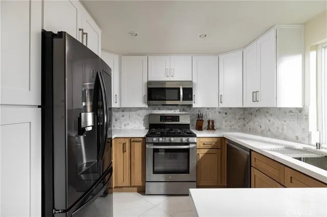 a kitchen with a refrigerator stove and microwave