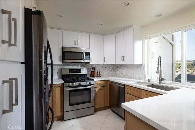 a kitchen with a sink stove and microwave