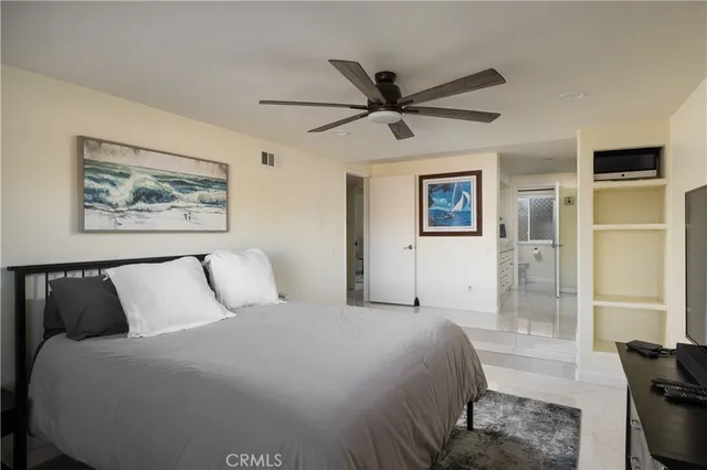 a bedroom with a bed and a painting on the wall