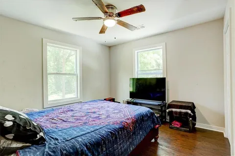 a bedroom with a bed and a flat tv screen
